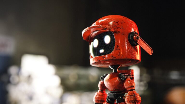 Cute ascetic red robot With Glowing eyes looking for you
