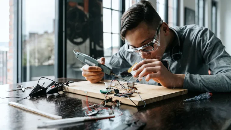 Man Soldering Wires with pencil Soldering Iron